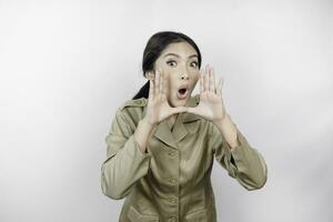 Young beautiful civil worker woman is shouting or yelling isolated by a white background. Communication concept photo