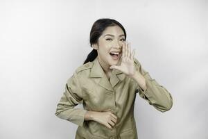 Young beautiful civil worker woman is shouting or yelling isolated by a white background. Communication concept photo