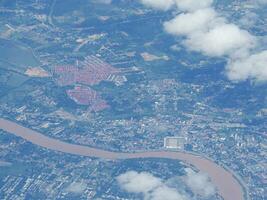 Aerial view of agricultural field and river seen through airplane window photo