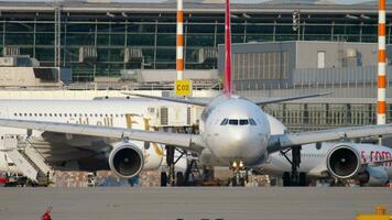 DUSSELDORF, GERMANY JULY 21, 2017 - Turkish Airlines Airbus A330 TC JIM taxiing before departure at sunset. Dusseldorf airport video