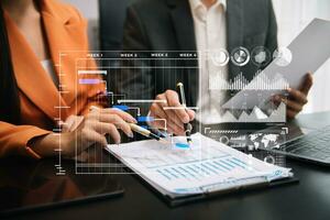 Business team hand Project manager working and update tasks and Gantt chart scheduling virtual diagram.with smart phone, tablet and laptop in office. photo