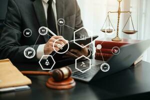 justice and law concept. asian woman lawyer working and judge in a courtroom the gavel, working with tablet and laptop on table photo