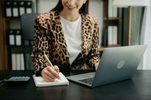 Working Process in Modern Office. Young Woman Account Manager Working at Table with New Business Project. Typing keyboard,Using Contemporary Laptop. photo