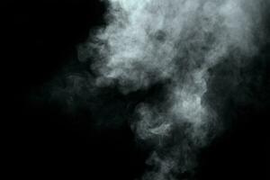 Abstract  powder or smoke isolated on black background photo