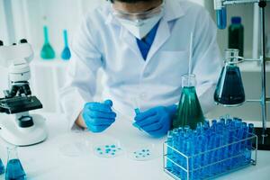 Male scientist researcher conducting an experiment working in chemical laboratory photo