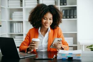 Woman using smart phone for mobile payments online shopping,omni channel,sitting on table,virtual icons graphics interface screen i photo