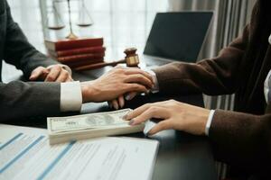 Judge gavel with scales of justice, Business and lawyer or counselor consulting and discussing contract papers with laptop and tablet at law firm photo