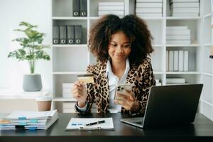 Woman using smart phone for mobile payments online shopping,omni channel,sitting on table,virtual icons graphics interface screen in morning light photo