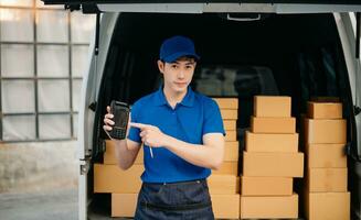 Portrait of courier delivery Asian man searching the address on digital tablet. Delivery service, delivery home and shipping concept. photo