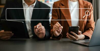 Searching Browsing Internet Data Information Networking Concept. two businessman hand using smart phone,mobile and tablet in office. photo