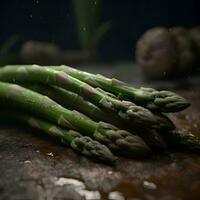 Fresh green asparagus on a rustic table with water drops photo