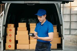 Portrait of courier delivery Asian man searching the address on digital tablet. Delivery service, delivery home and shipping concept. photo