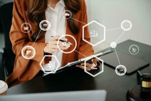 justice and law concept. Female judge in a courtroom the gavel, working with smart phone and laptop and digital tablet computer on table with VR icon photo