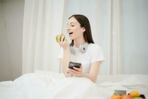 Good Healthy woman drinking tea and resting in white bed at bedroom. Lifestyle at home concept in morning photo