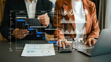 Businessman hand Project manager working and update tasks and Gantt chart scheduling virtual diagram.with smart phone, tablet photo