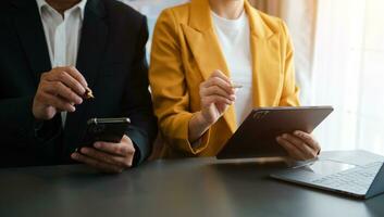 Business documents on office table with smart phone and calculator digital tablet and graph photo