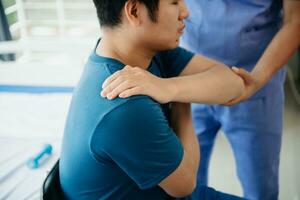 Doctor consulting with patient Back problems Physical on the bed in clinic concept photo