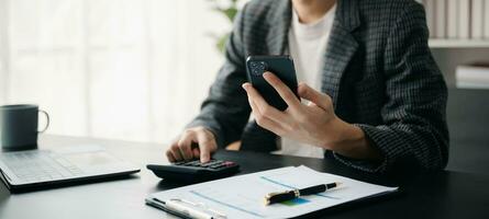 Businessman s hands typing on smartphone, tablet and laptop keyboard computer, typing, online in office photo