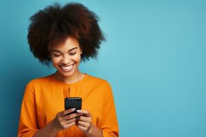 Woman with curly hair is using her smartphone and smiling photo