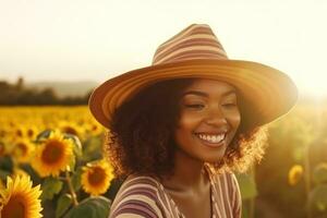 Beautiful woman in a straw hat standing in a sunflower field photo