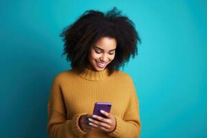 Woman with curly hair is using her smartphone and smiling photo