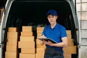 Portrait of courier delivery Asian man searching the address on digital tablet. Delivery service, delivery home and shipping concept. photo