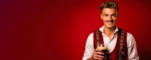 Young man in traditional German clothes with beer on solid red background photo