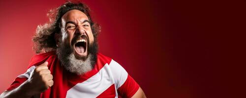 Tunisian football fan celebrating a victory on red and white background with empty space for text photo