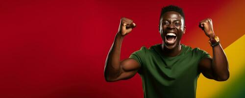 Senegalese football fan celebrating a victory on green yellow and red background with empty space for text photo