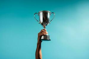 Golfer raising the championship trophy after a hard-fought win on blue background with empty space for text photo