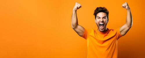 American football fan celebrating a victory on orange background with empty space for text photo