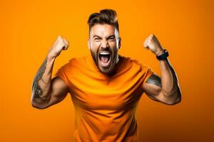 American football fan celebrating a victory on orange background with empty space for text photo
