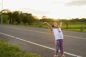 Healthy woman celebrating during beautiful happy sunset. photo