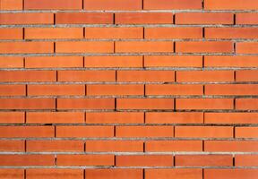 Red brick wall with gray seams textured background. photo