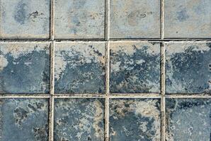 Close-up rough black dirty pavement squares texture photo