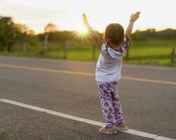 Healthy woman celebrating during beautiful happy sunset. photo