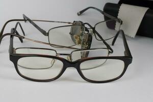 A bunch of old prescription eyeglasses photo