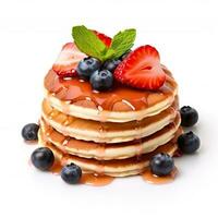 Delicious pancakes with strawberry and blueberries isolated on white background photo