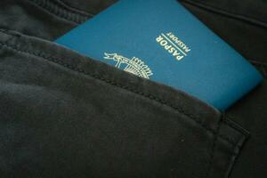 An Indonesian citizenship passport in a green denim pocket. photo