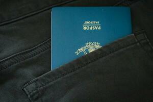 An Indonesian citizenship passport in a green denim pocket. photo