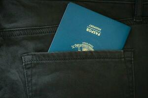 An Indonesian citizenship passport in a green denim pocket. photo