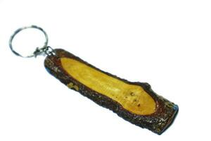 Isolated white of a key ring in the shape of a piece of wood. photo