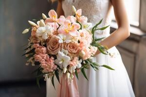 A beautiful bride holding her pink and white wedding bouquet photo