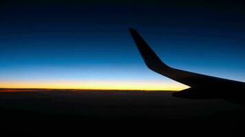 Night view from the airplane, night sky with Venus star before sunrise and wing of an airplane video