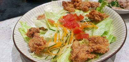 Indonesian japanese fusion food, japanese food cook in indonesian style, gyukatsu, beef karage, salad, and tofu soup photo