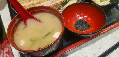 Indonesian japanese fusion food, japanese food cook in indonesian style, gyukatsu, beef karage, salad, and tofu soup photo