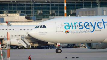 DUSSELDORF, GERMANY JULY 21, 2017 - Air Seychelles Airbus 330 S7 VDM taxiing to the start at sunset. Dusseldorf airport video