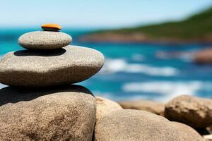 Balanced pebble pyramid on the beach on a sunset time. Sea waves on the background. Selective focus. Zen stones on the sea beach,, calmness, balance concept photo