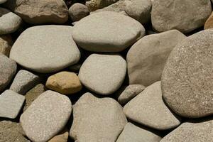 Background of pile of large stones of a rounded oval shape photo