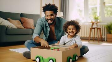 Father and son are playing at home with pretend car in a box photo